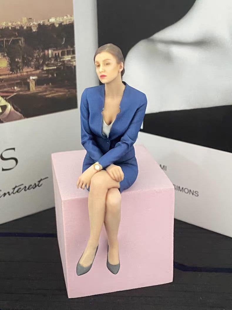 Custom seated portrait figurine displayed on a pink block